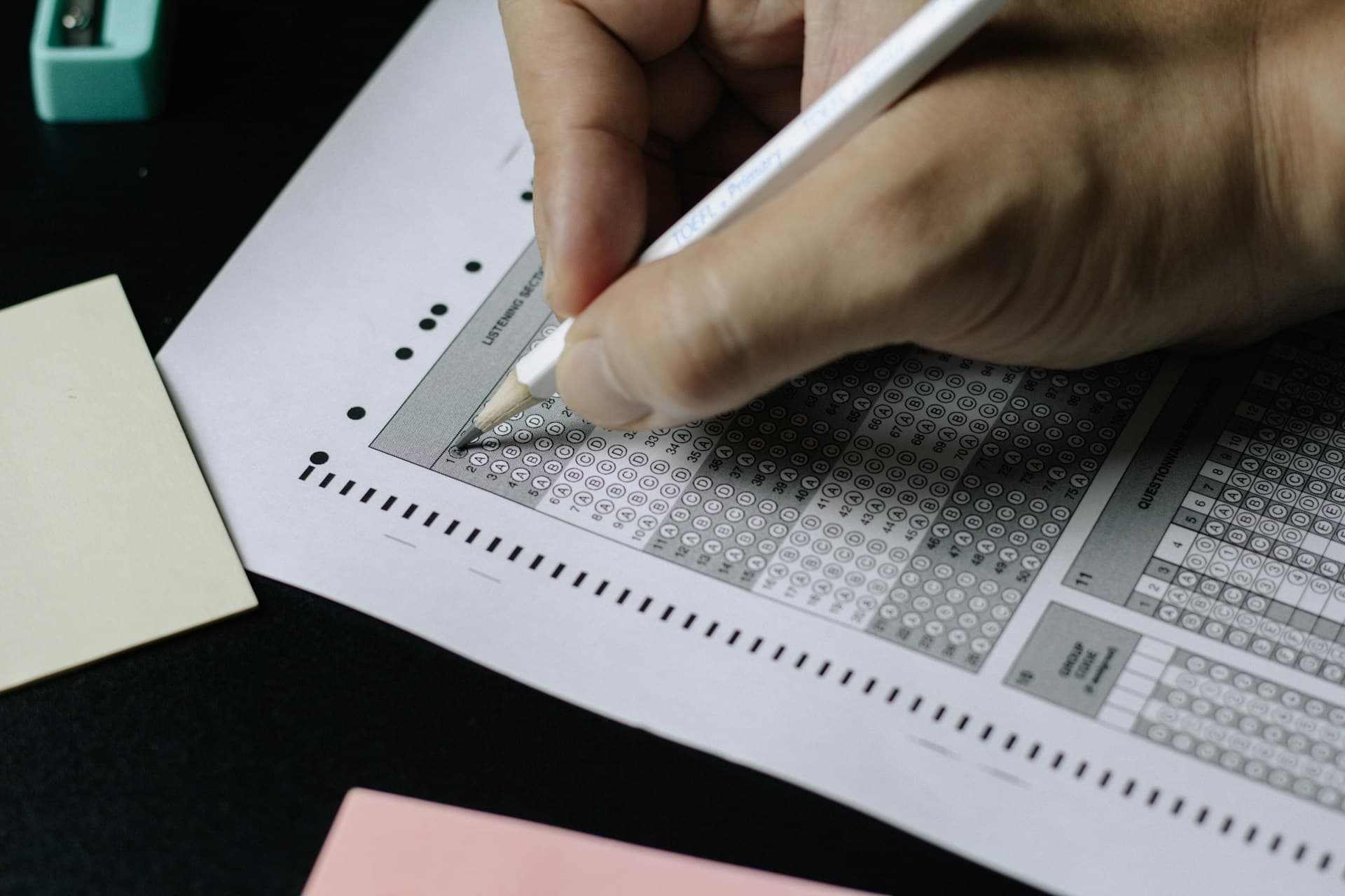 A student filling in a standardized test answer sheet with a pencil